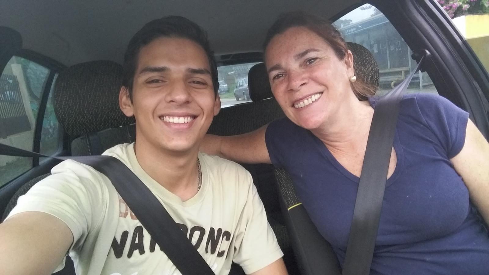 Gus in the car with the owner of the first hostel